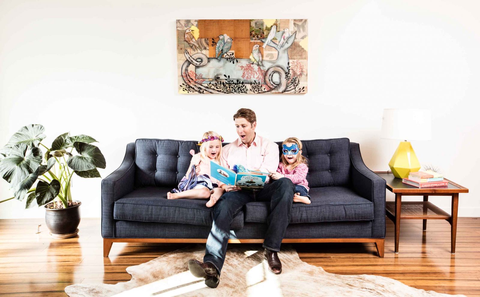 Father and children sitting on designer couch